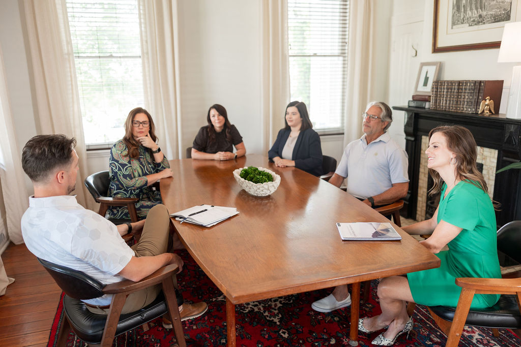 Business leaders gathered around a conference table during a marketing strategy discussion.