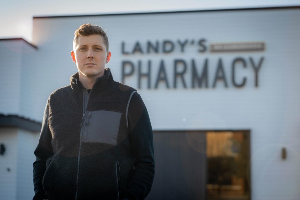 Local business owner standing outside a newly built commercial building.